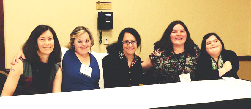 Photo of five women at conference.