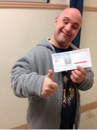 Photo of Christian holding his state ID and giving a thumbs up